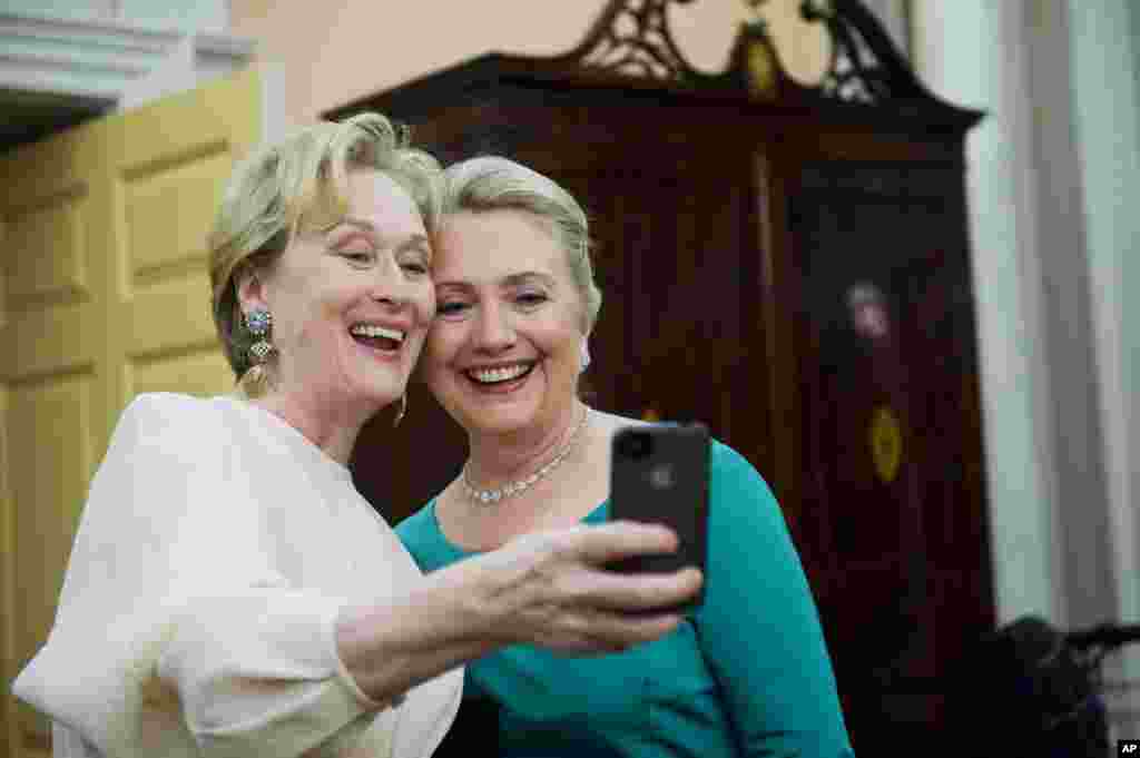 Actress Meryl Streep uses her iPhone to get a photo of her and Secretary of State Hillary Clinton following the State Department Dinner for the Kennedy Center Honors, December 1, 2012.