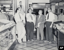 Howard Miller (left) with family members in the men's casual pants department, believed to have been taken in the 1950s.