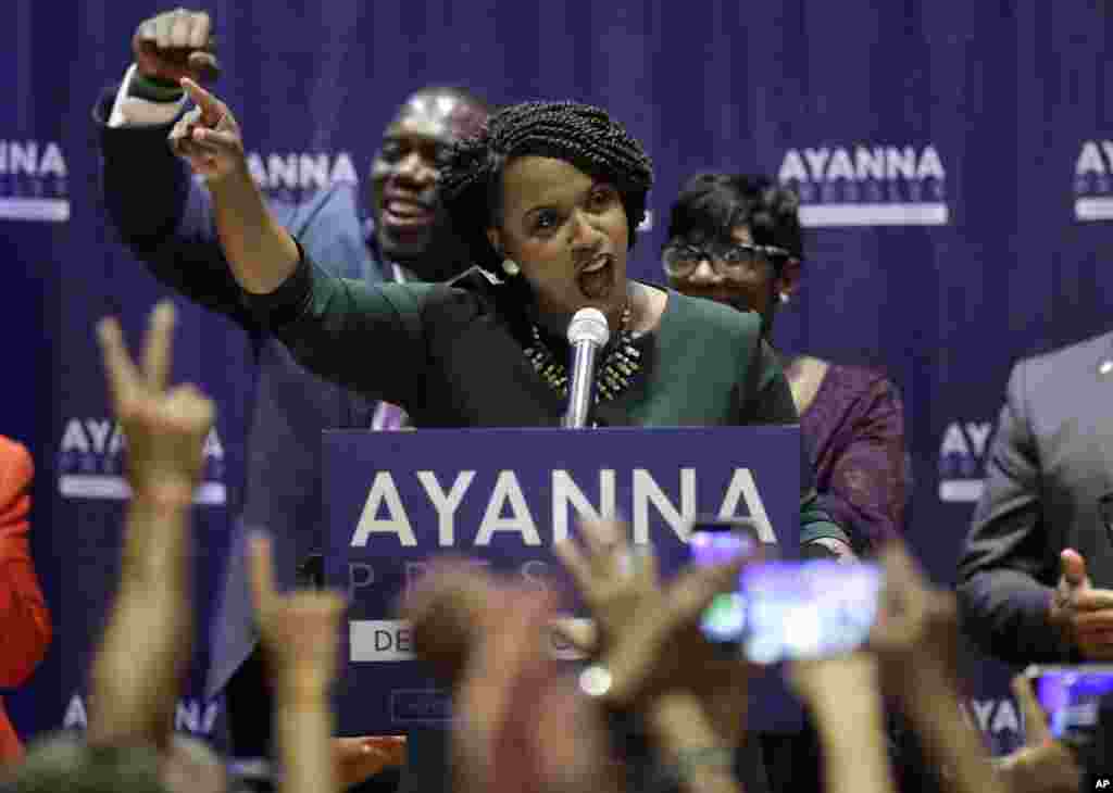 Boston City Councilor Ayanna Pressley, center, celebrates her victory over U.S. Rep. Michael Capuano, D-Mass., in the 7th Congressional House Democratic primary, in Boston, Sept. 4, 2018.