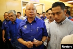 FILE - Malaysia's outgoing Prime Minister Najib Razak walks to a news conference to concede the general election in Kuala Lumpur, Malaysia, May 10, 2018.