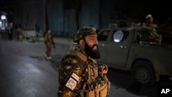 Taliban fighters block roads after an explosion Tuesday, Nov. 2, 2021. An explosion went off Tuesday at the entrance of a military hospital in Kabul, killing several people and wounding over a dozen, health officials said.