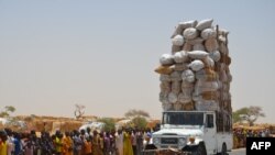 FILE: An overloaded car travels through the Assaga refugee camp in Diffa on May 17, 2016, close to the Niger-Nigeria border. 