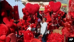 Valentine's Day around the world! A shop owner prepares for Valentine's Day in Baghdad, Iraq, February 11, 2015. Despite violence, some Iraqis celebrate Valentine's Day by buying gifts for their loved ones. (AP Photo/Khalid Mohammed)