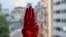 An anti-coup protester shows the three-fingered salute of resistance on his red painted hand in memory of protesters who lost their lives, in Yangon, Myanmar.