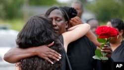 Veda Sterling, aunt of Alton Sterling, hugs a visitor at Alton's burial at the Mount Pilgrim Benevolent Society Cemetery in Baton Rouge, Louisiana, July 15, 2016. 