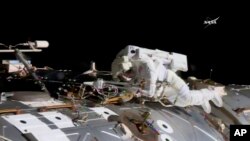 In this NASA provided frame from video, NASA astronaut Jack Fischer works to install antennas at the International Space Station while astronaut Peggy Whitson, not pictured, works on repairs Tuesday, May 23, 2017. 