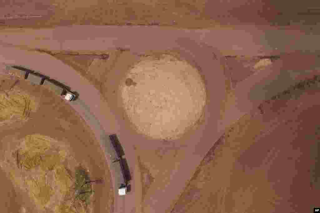 Cargo trucks turn off the Trans-Amazon highway, top, onto route BR-163 in Campo Verde, near Itaituba, Para state, Brazil.