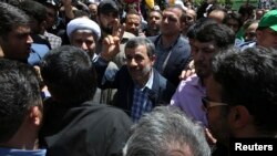 Former Iranian President Mahmoud Ahmadinejad (C) flashes a victory sign while attending the annual anti-Israeli Al-Quds, Jerusalem, Day rally in Tehran, Iran, June 8, 2018. 