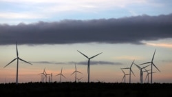 FILE - Iberdrola's power generating wind turbines are seen at dusk at the Moranchon wind farm in central Spain.