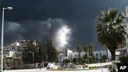 Black smoke rises from buildings in Homs, Syria, March 27, 2012 (AP is unable to independently verify the authenticity, content, location or date of this handout photo.)