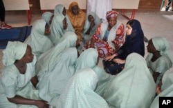 Pakistani activist Malala Yousafzai, far right, speaks with schoolgirls in Maiduguri, Nigeria, July. 18, 2017.