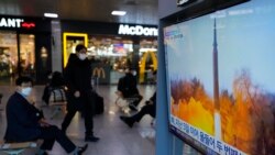 A TV shows a file image of North Korea's missile launch during a news program at the Seoul Railway Station in Seoul, South Korea, Jan. 11, 2022.