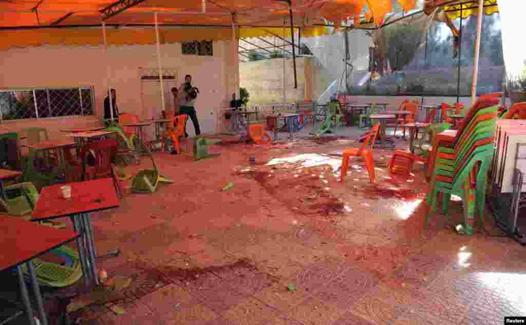 Debris and blood are seen after mortar bombs landed on the canteen of Damascus University's College of Architecture, March 28, 2013.