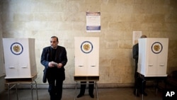 Armenian voter holds ballot paper at polling station during parliamentary election, Yerevan, May 6, 2012.