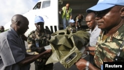 The bodies of the United Nations peacekeepers killed in western Ivory coast near the Liberia border arrive in Abidjan June 9, 2012. 