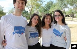 Wearing T-shirts with the message "Free the Citgo 6," the Vadell family poses for a photo in Katy, Texas, Feb. 15, 2019.