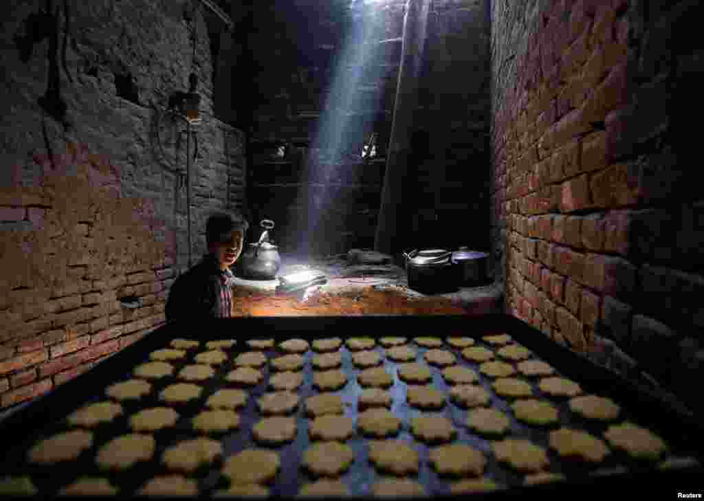 An Afghan man makes sweets at a small traditional factory during the holy Muslim fasting month of Ramadan in preparation for Eid al-Fitr in Kabul.