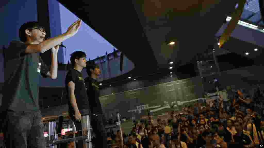 Joshua Wong, 17-year old student leader, address protesters during a rally in the occupied areas at Central district in Hong Kong, Oct. 9, 2014. 