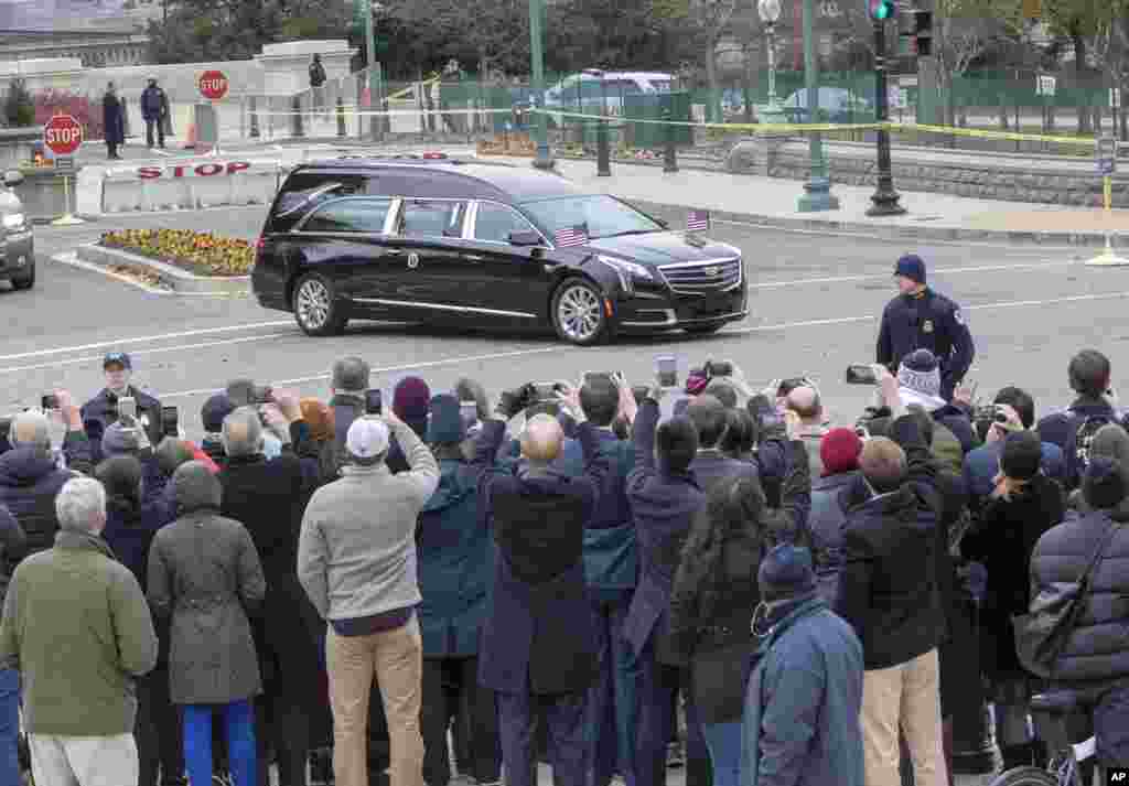 The hearse bearing the casket of former President George H.W. Bush leaves the Capitol on the way to a State Funeral at Washington National Cathedral, Dec. 5, 2018.