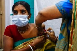 FILE - A health worker administers a dose of Covaxin COVID-19 vaccine at a health center in Garia, South 24 Pargana district, India, Oct. 21, 2021.