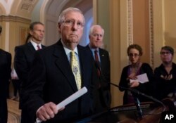 Senate Majority Leader Mitch McConnell, R-Ky., joined from left by Sen. John Thune, R-S.D., and Majority Whip John Cornyn, R-Texas, speaks to reporters on Capitol Hill in Washington, April 17, 2018.