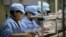 FILE - Chinese women work at a technology factory in southern China.