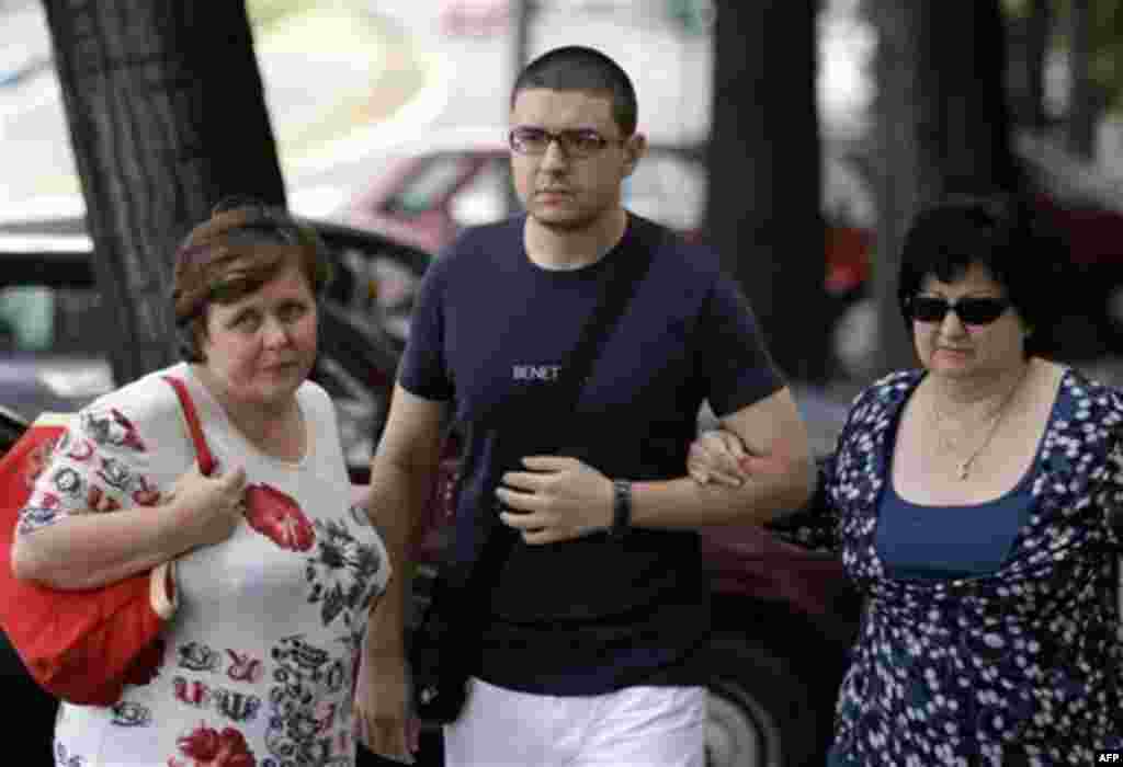 Goran Hadzic's son Srecko Hadzic, center, wife Zivka Hadzic, right and sister Goranka Meseldzija, arrive at the Special Court building in Belgrade, Serbia, Thursday, July 21, 2011. The last Balkan war crimes suspect sought by the U.N. war crimes tribunal