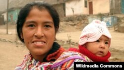 Sensitive care provides lasting benefits to youngsters, research shows. Here, a Peruvian mother carries her baby in the hills above Lima. (Photo courtesy of Ian Riley / Wikipedia Commons)