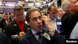 Traders work on the floor of the New York Stock Exchange in New York City, July 15, 2016.