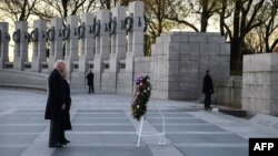 US President Joe Biden and First Lady Jill Biden place a wreath at the World War II Memorial to mark National Pearl Harbor Remembrance Day in Washington, DC, on December 7, 2021. (Photo by Nicholas Kamm / AFP)