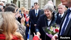 Britain's Prime Minister Theresa May greets people after visiting the scene where former Russian intelligence officer Sergei Skripal and his daughter Yulia were found after they were poisoned with a nerve agent, in Salisbury, Britain, March 15, 2018.