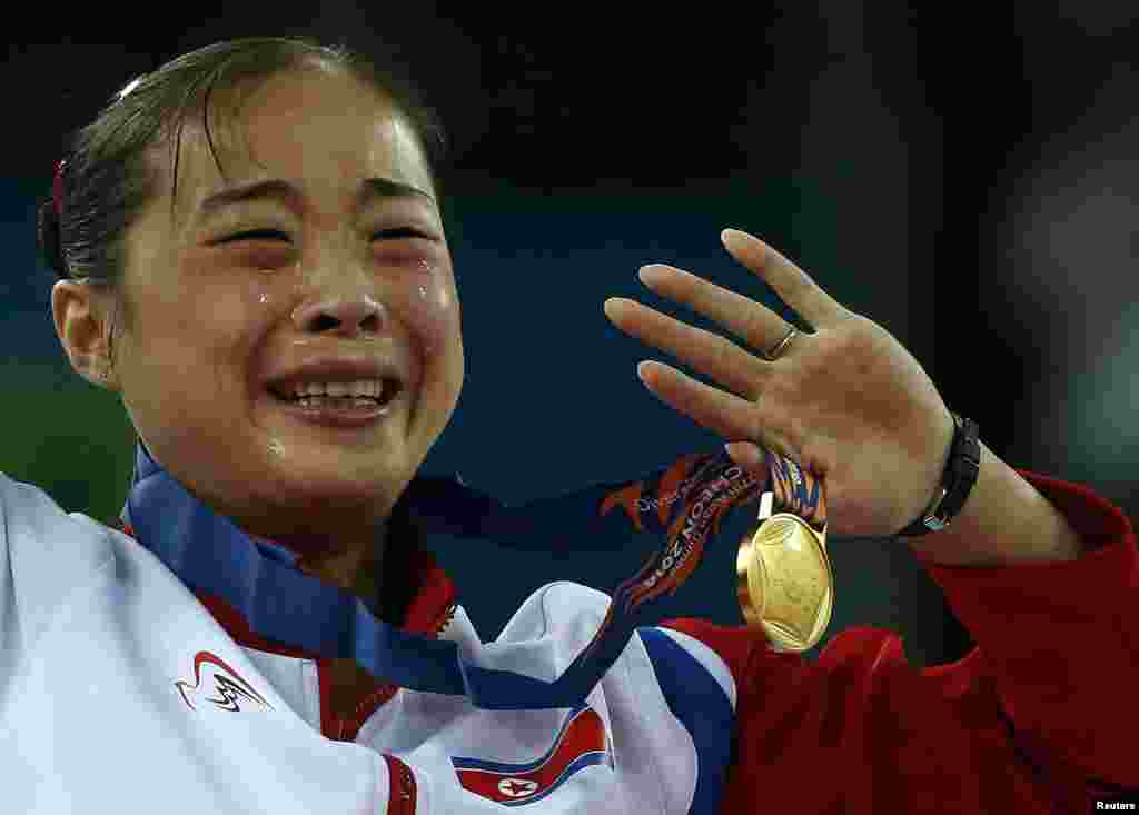 North Korea's gold medalist Kim Un Hyang cries during the medal ceremony for the women's beam final of the artistic gymnastics competition at the Namdong Gymnasium Club during the 17th Asian Games in Incheon, South Korea.