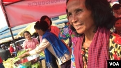 Ton Son (R) is seen waiting for customers at the community market in Kompong Speu province. (Photo - Hul Reaksmey/VOA Khmer)