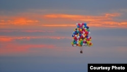 Jonathan Trappe is seen flying is cluster balloon ship on September 12, 2013. (Paul Cyr Barcroft media)