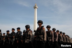 FILE - Anti-riot police stand during security preparations ahead of the protest by hard-line Muslim groups in Jakarta, Indonesia, Nov. 2, 2016.