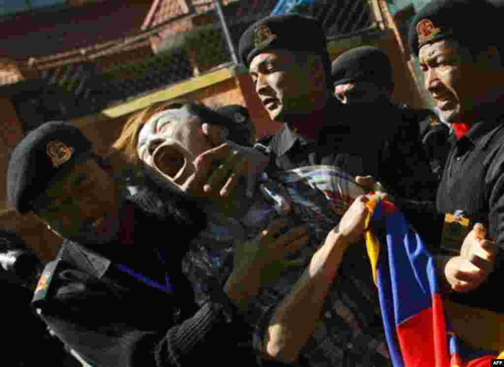 Nepalese policemen detain an exile Tibetan who was shouting anti-Chinese slogans during a protest outside United Nations office in Katmandu, Nepal, Friday, Feb. 24, 2012. Police in Nepal's capital detained a small group of Tibetans who tried to storm the 