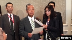 Japanese trade minister Akira Amari speaks to reporters during a break in the Trans-Pacific Partnership talks in Atlanta, Oct. 3, 2015. 