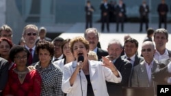 Brazil's President Dilma Rousseff speaks after leaving Planalto presidential palace in Brasilia, May 12, 2016. 