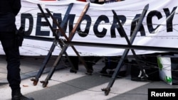 FILE - A pro-democracy banner is pictured during a protest in Brussels, Belgium, Oct. 19, 2018. The Biden administration is sponsoring a virtual Summit for Democracy to be held Dec. 9-10.