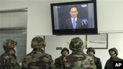 South Korean marines watch a live television broadcast of President Lee Myung-bak's speech, on Yeonpyeong Island, South Korea, Monday, Nov. 29, 2010. Lee took responsibility for failing to protect his citizens from a deadly North Korean artillery attack l