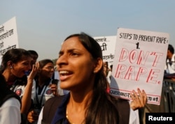 FILE - Students from various colleges hold placards as they shout slogans during a rally against gender discrimination and violence toward women in Mumbai, Dec. 10, 2014.