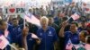 Malaysia's Prime Minister Najib Razak (C) waves a national flag as he sings patriotic songs with supporters during an election campaign rally in Rawang, outside Kuala Lumpur April 28, 2013.