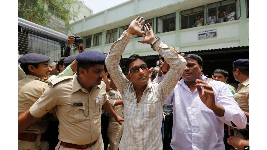 An Indian man convicted for the 2002 Gujarat riots is taken back to jail after the court announced the lengths of the sentences in Ahmadabad, India on June 17, 2016.