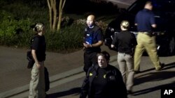 Agents with the Bureau of Alcohol, Tobacco, Firearms and Explosives leave after searching the family home, in Baltimore, Sunday, Aug. 26, 2018, of the suspect in a mass shooting earlier in the day in Jacksonville, Fla.