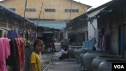 A girl stands in front of a rented house, frequented by garment workers, locate near Veng Sreng road on July 24, 2015. (Sou Pisen/VOA Khmer)