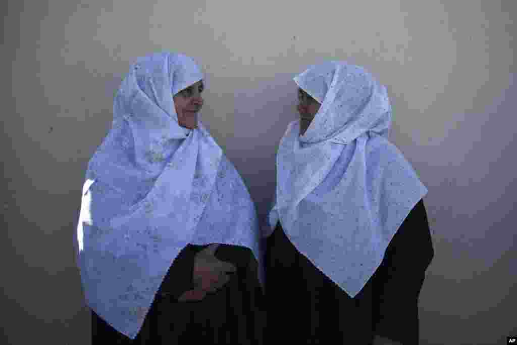 Two women wait for the visit of the Turkish President Recep Tayyip Erdogan at Kirmahalle Cammi mosque in the northeastern Greek town of Komotini.