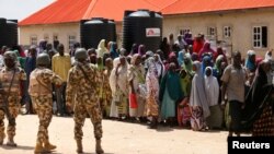 Security officers are called to control some of the internally displaced people at the Bakkasi camp. The people were upset at camp authorities for what they say is poor distribution of food rations, in Borno, Nigeria, on August 29, 2016.