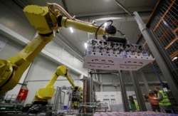 Robotic arms sort and load yogurts onto pallets at a distribution centre near Prague, Czech Republic, February 17, 2020. Picture taken February 17, 2020.