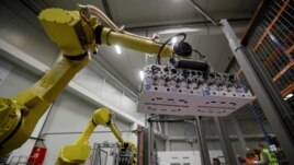 Robotic arms sort and load yogurts onto pallets at a distribution centre near Prague, Czech Republic, February 17, 2020. Picture taken February 17, 2020.