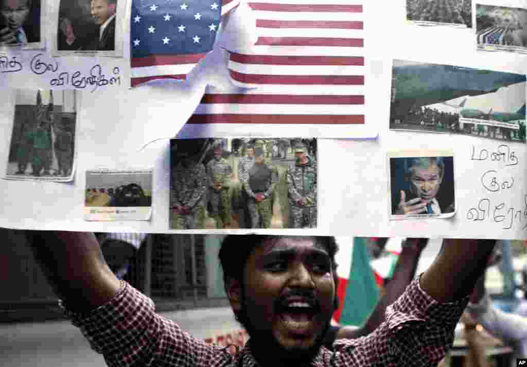 Un Indien tenant un pancarte et criant des slogans durant une manifestation devant l'ambassade des Etats-Unis à Chennai, en Inde